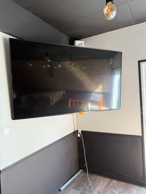 a flat screen tv mounted on the wall in a room