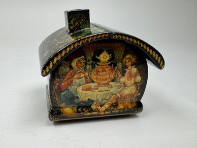 a small box with a painting on it on a table