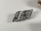 a small piece of metal that is sitting on a table