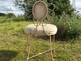a chair that is sitting in the grass in the field
