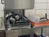 a kitchen with a sink, stove, and dishwasher in it