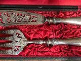 a silverware set in a red box on a table