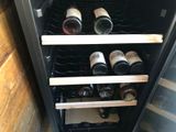 many bottles of wine sitting in a wine cooler
