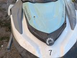 a white and black jet ski parked on the side of the road