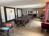 a room with a long table and chairs in it