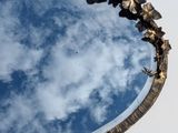 a mirror that has a reflection of a sky and clouds in it