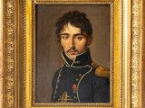un tableau représentant un homme en uniforme militaire, dans un cadre doré