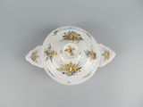a white bowl with yellow and blue flowers on it