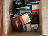 a cardboard box filled with books and other items
