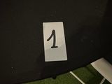 a table with a number one on it and a chair next to it