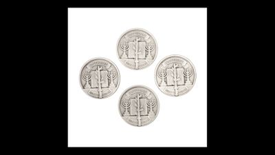 four silver coins sitting on top of each other on a white surface