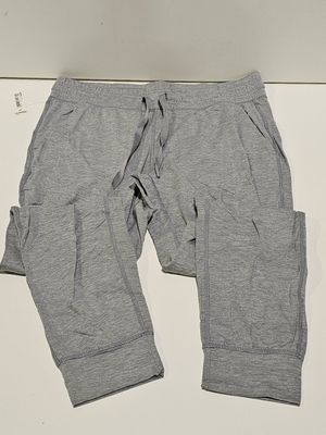 grey sweat pants with pockets on a white surface