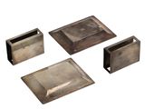 four pieces of silver metal on a white surface with a white background