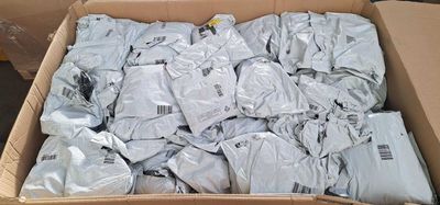 a cardboard box filled with a large amount of clothing