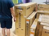 a man that is standing in front of a pile of boxes