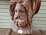 a bust of a man with a beard on a chair