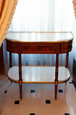 a small table with a marble top in a room