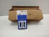 a box of three empty toothbrushes sitting on a table