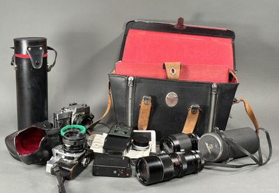 many different types of cameras and a case on the table