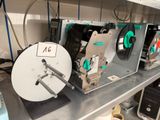 many machines that are sitting on a shelf in a room