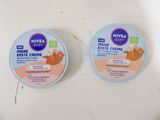 two containers of nivea baby cremes sitting on a table