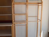 a shelf that has a book case on it in the corner of a room