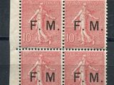 four stamps with a woman on them on a black surface