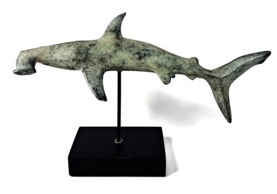 sculpture of a shark on a black stand on a white background