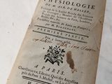 Quelqu'un tient un livre sur lequel figure un titre ancien.