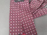 chanel tie in pink and red with a chanel logo on it