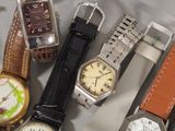 a lot of watches that are sitting on a table
