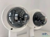 two cameras mounted on the wall of a room