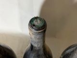 three bottles of wine sitting next to each other on a table