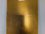 an image of a piece of gold foil with a cloud in the sky