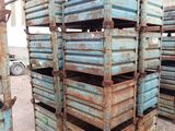 many crates stacked on top of each other in the dirt