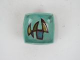 a small bowl with a sailboat design on it