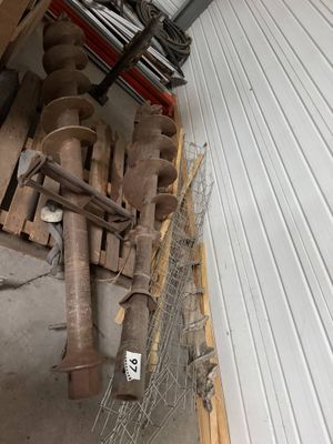 a pile of pipes and other items in a garage