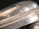 two silver dishes sitting on top of each other