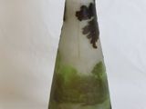 a glass vase with a green and black design on it