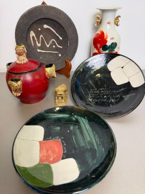 many plates and vases sitting on a table