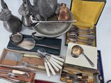 a tray with silverware and other silverware on a table