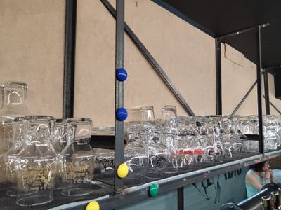 many empty glasses on a shelf in a room