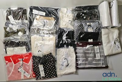 many different types of shirts and ties on the table