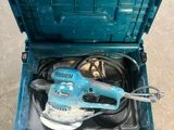 a blue box with a sander inside of it