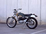 a motorcycle parked in a parking lot next to a wall