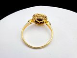 a close up of a gold ring on a white surface