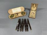 a box of pens and a pair of glasses on a table