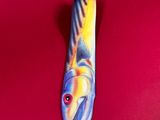 a tie that has a fish on it on a red surface