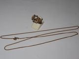 necklace and ring with chain on white surface