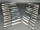 a lot of knives that are sitting on a table